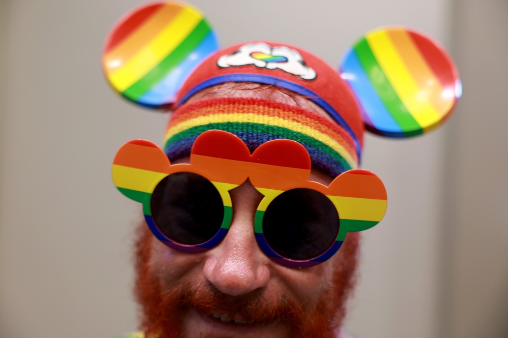 Russell Eaves wears Mickey Mouse glasses and ears during the Gay Days festivities.