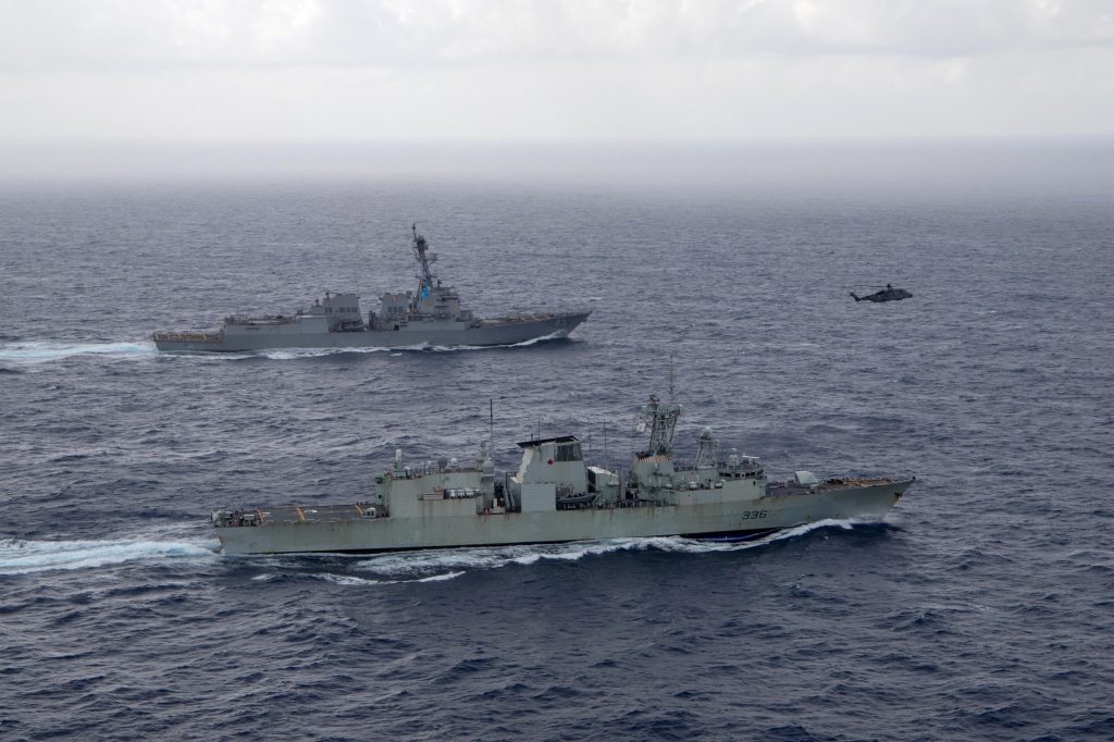 U.S. Navy guided-missile destroyer USS Chung-Hoon sails alongside the Royal Canadian Navy frigate HMCS Montreal during Surface Action Group operations as a part of exercise in the South China Sea.