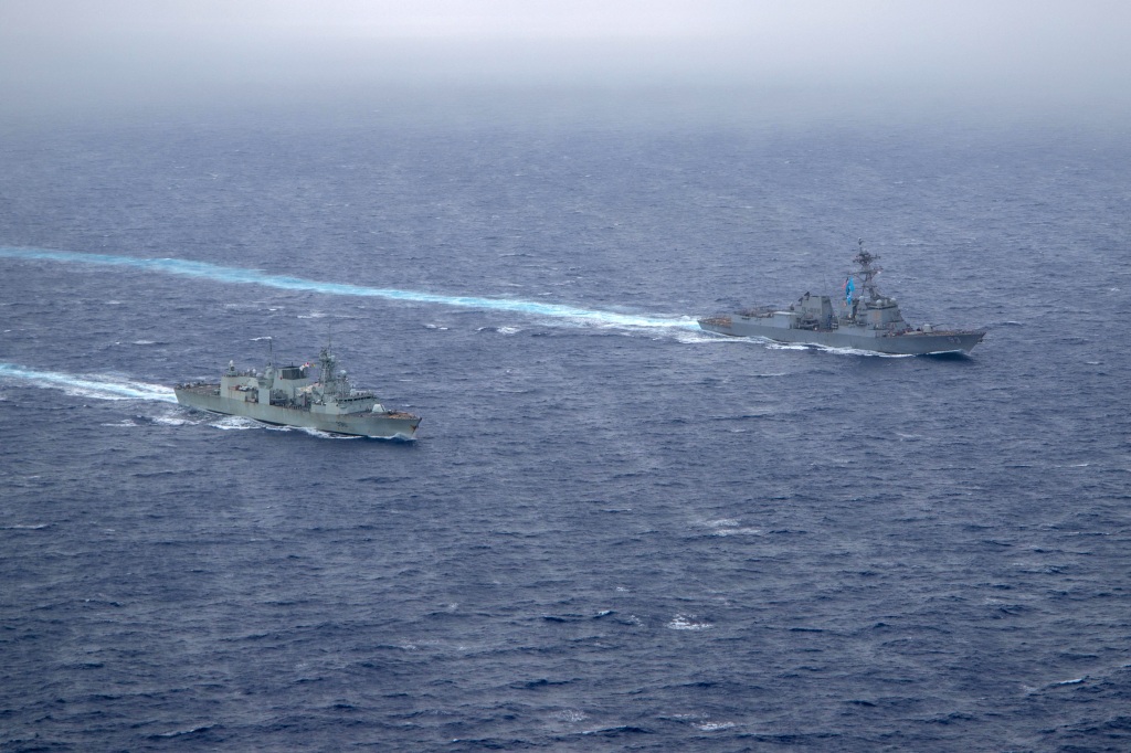 U.S. Navy guided-missile destroyer USS Chung-Hoon sails alongside the Royal Canadian Navy frigate HMCS Montreal during Surface Action Group operations as a part of exercise in the South China Sea.