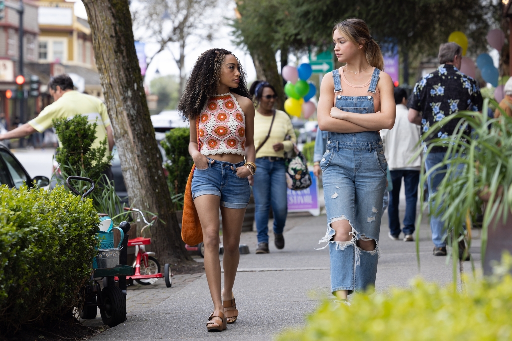 Sadie Stanley and Lexi Underwood walking down a sidewalk chatting. 
