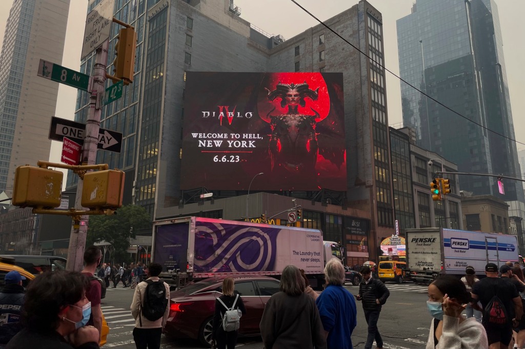 The billboard which promotes the new "Diablo IV" game features Lilith, one of the game's antagonists, and perfectly captures the city's mood. 