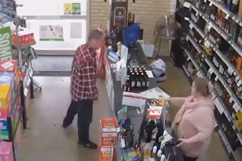 Man in red flannel places box onto counter of liquor store.