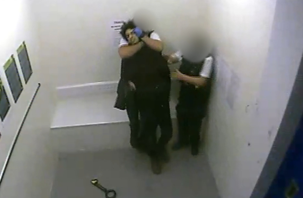 Screenshot of moment other officers grab the shooter.