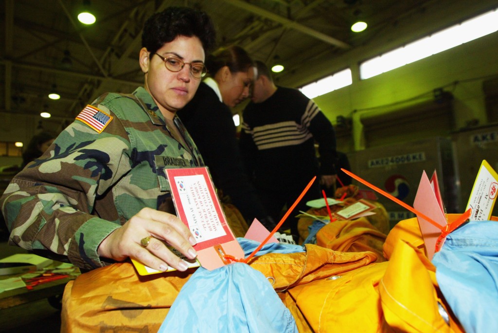 Major Tanya Bradsher, a member of U.S. Army, checks personal mail to be delivered to South Korean troops in Iraq, at the United States Forces Korea Military Mail Terminal (MMT) at Kimpo airport, January 27, 2005 in Seoul, South Korea.