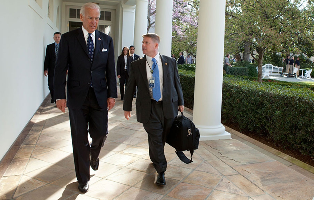 President Biden walks with an aide at the White House