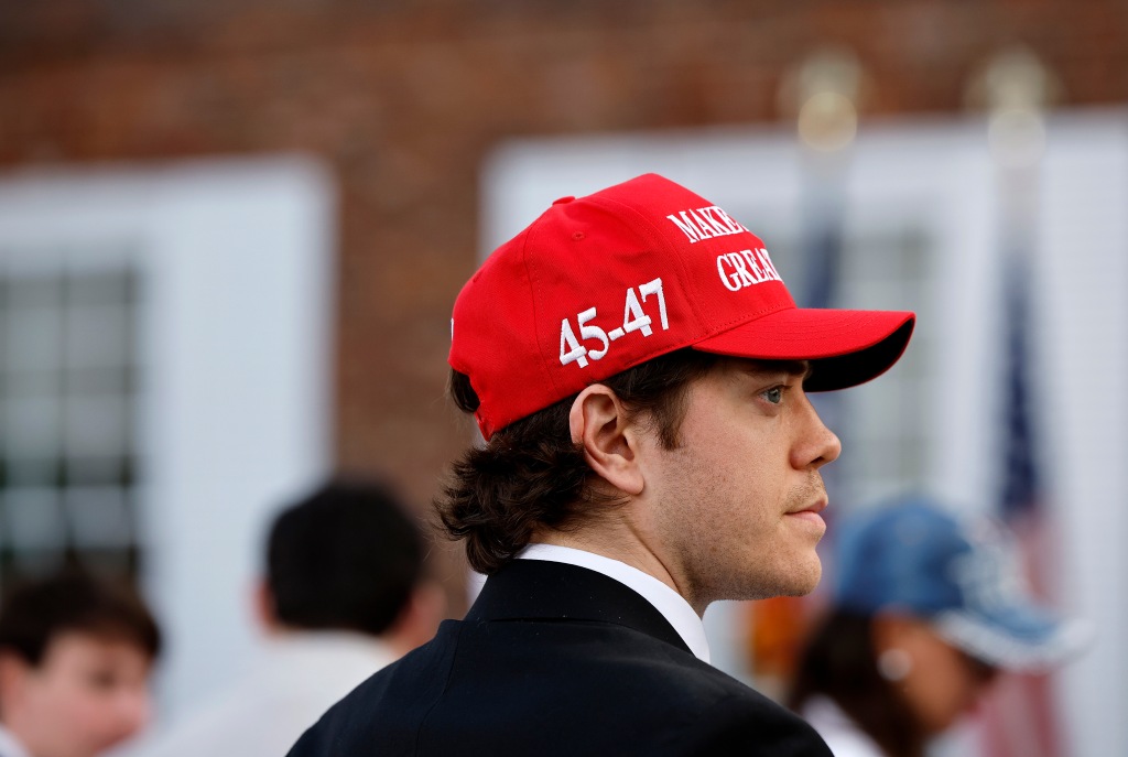 A guest wears a Trump campaign hat at the Trump National Golf Club ahead of a speech by former U.S. President Donald Trump.