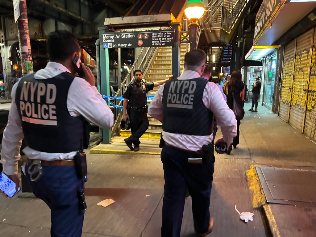 NYPD officers walking in the Marcy Ave subway station. 