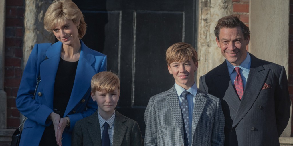 Elizabeth Debicki as Diana Princess of Wales, Will Powell as Prince Harry, Senan West as Prince William, Dominic West as Prince Charles in "The Crown" Season 5 smiling standing in a line. 