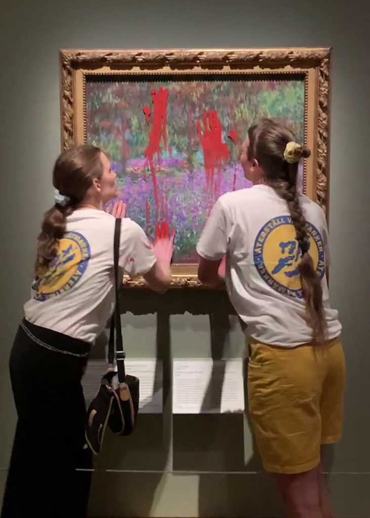 Two activists smearing paint on the painting "The Artist's Garden at Giverny"