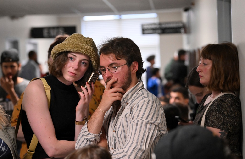 Emelyn Rutowski, 27, left, and Alessandro Uribe-Rheinbolt, 24, waiting for news on the vote.