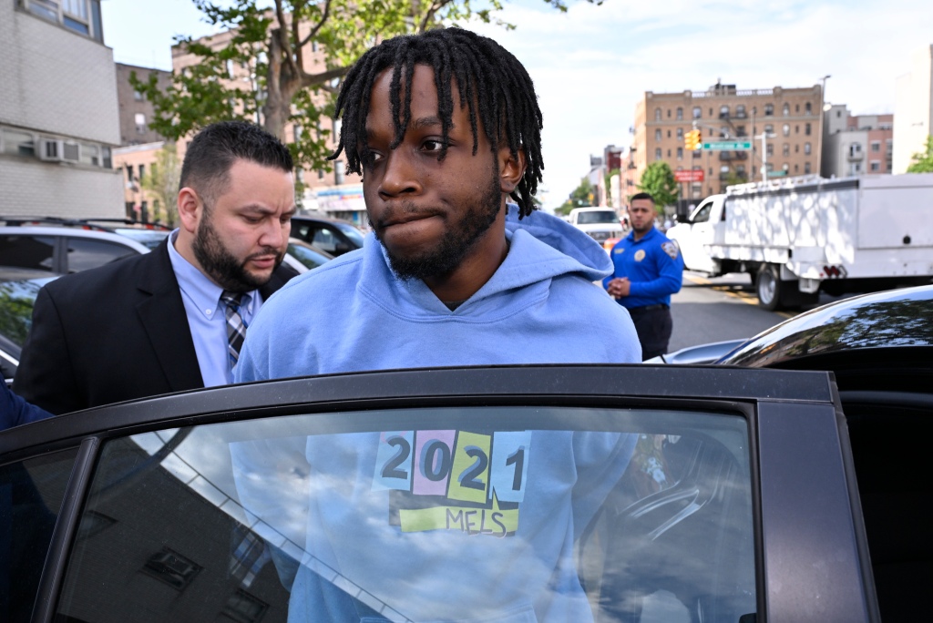 Jordan Williams handcuffed and getting into a police car. 