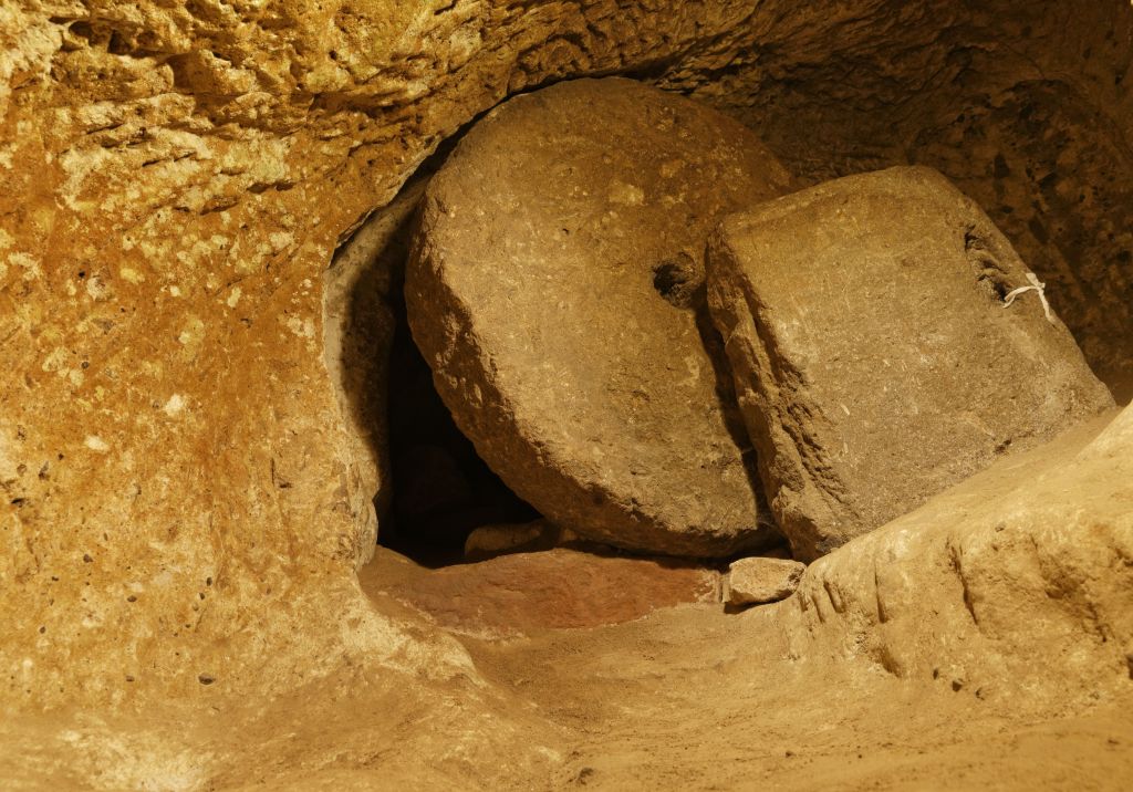 A boulder blocking a door in the tunnel.