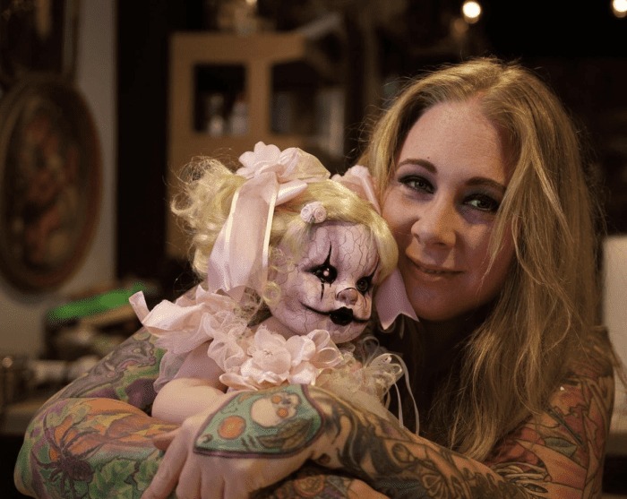 Katrina MacLean poses with a creepy clown doll. 