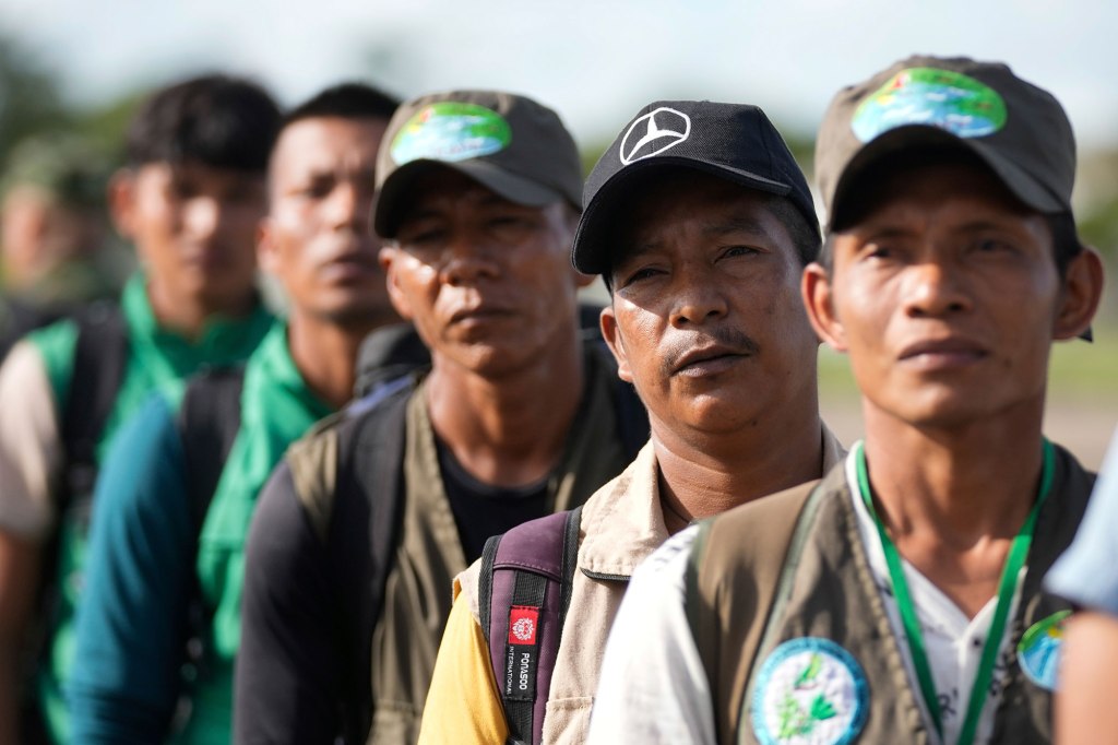 Indigenous rescuers in the forest.