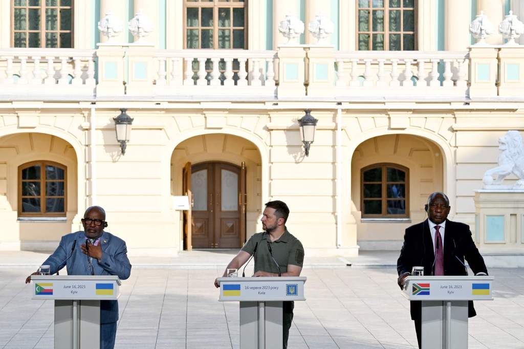 Ukraine's President Volodymyr Zelensky (C), flanked by South Africa's President Cyril Ramaphosa (R), listens to Comoros President Azali Assoumani as they address media after their talks in Kyiv on June 16, 2023.