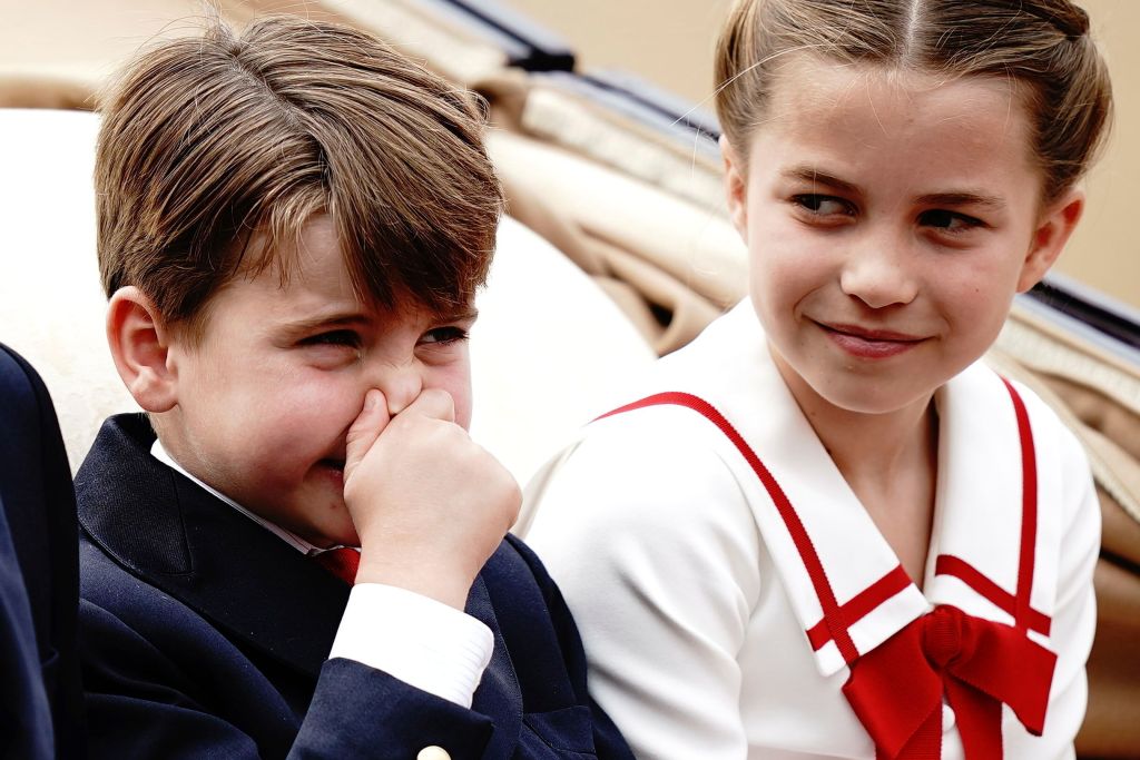 Prince Louis holds nose while Charlotte watches