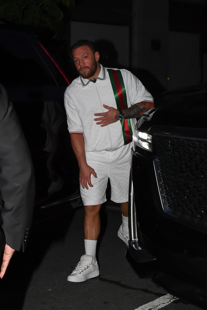 McGregor wore white shorts with a green and red stripe on the side, along with a matching Gucci polo shirt.