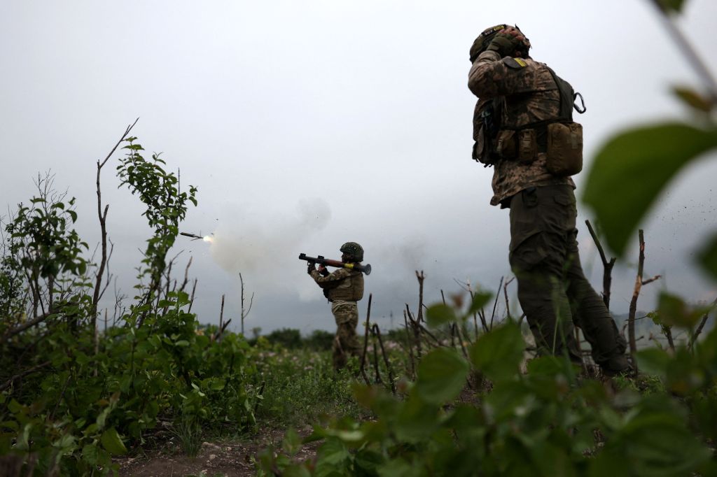 Ukrainian soldiers of the 28th Separate Mechanized Brigade fire a grenade launcher at the front line near the town of Bakhmut, Donetsk region, on June 17, 2023, amid the Russian invasion.