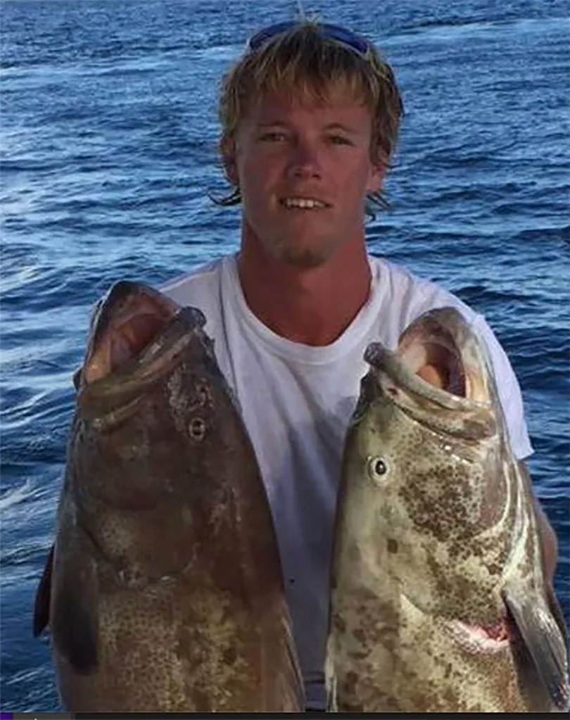 Tyler Nulisch holds up two fish in front of water in a past photo. 