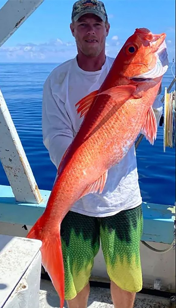 Tyler Nulisch holds up a large fish on a boat in a past photo. 