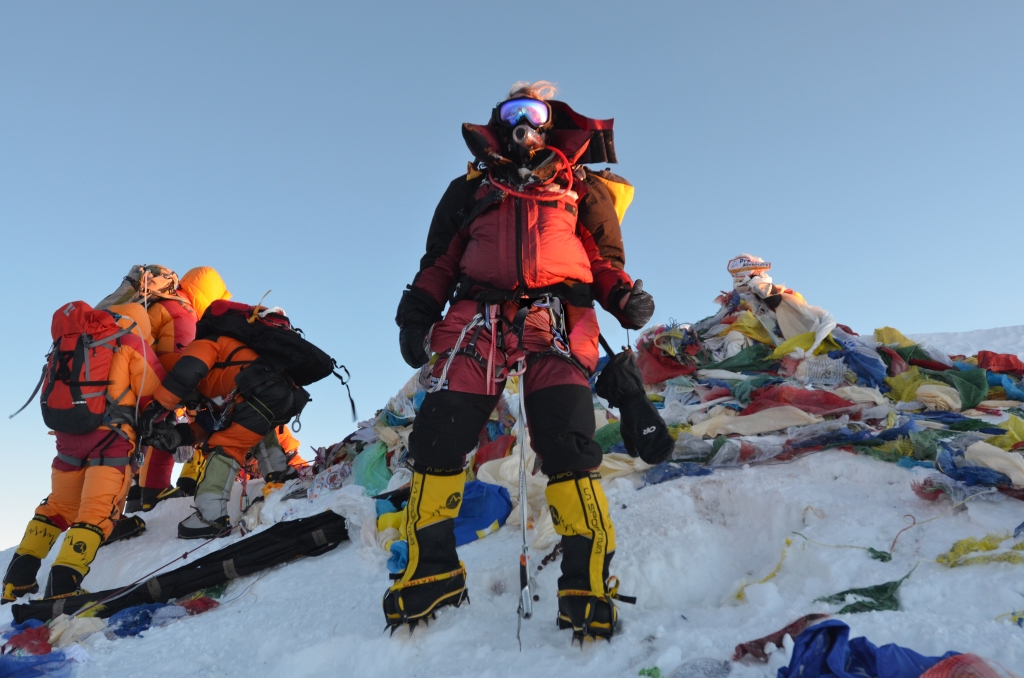 O'Brien on icy mountain top in climbing gear. 