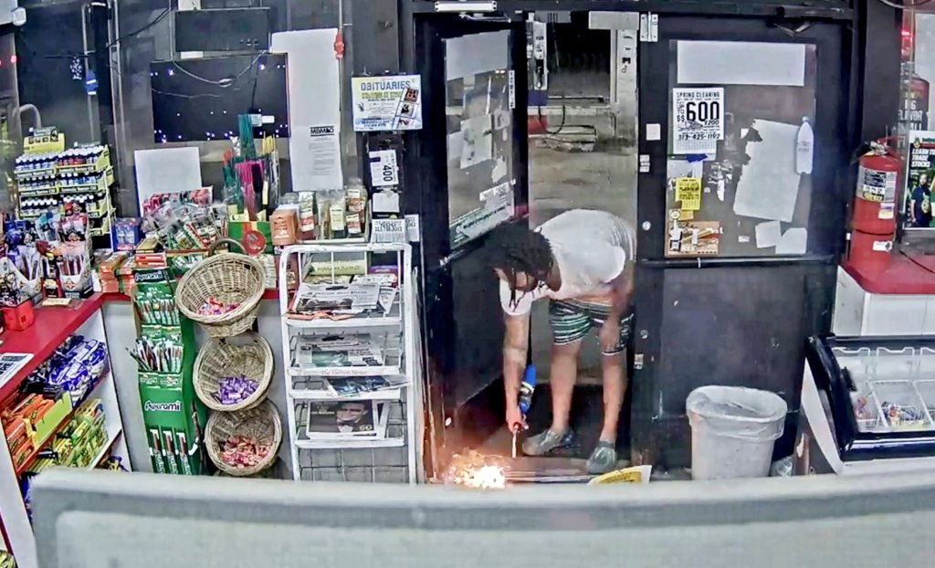 After arguing with the clerk, Miller set the garbage on fire with the torch. 