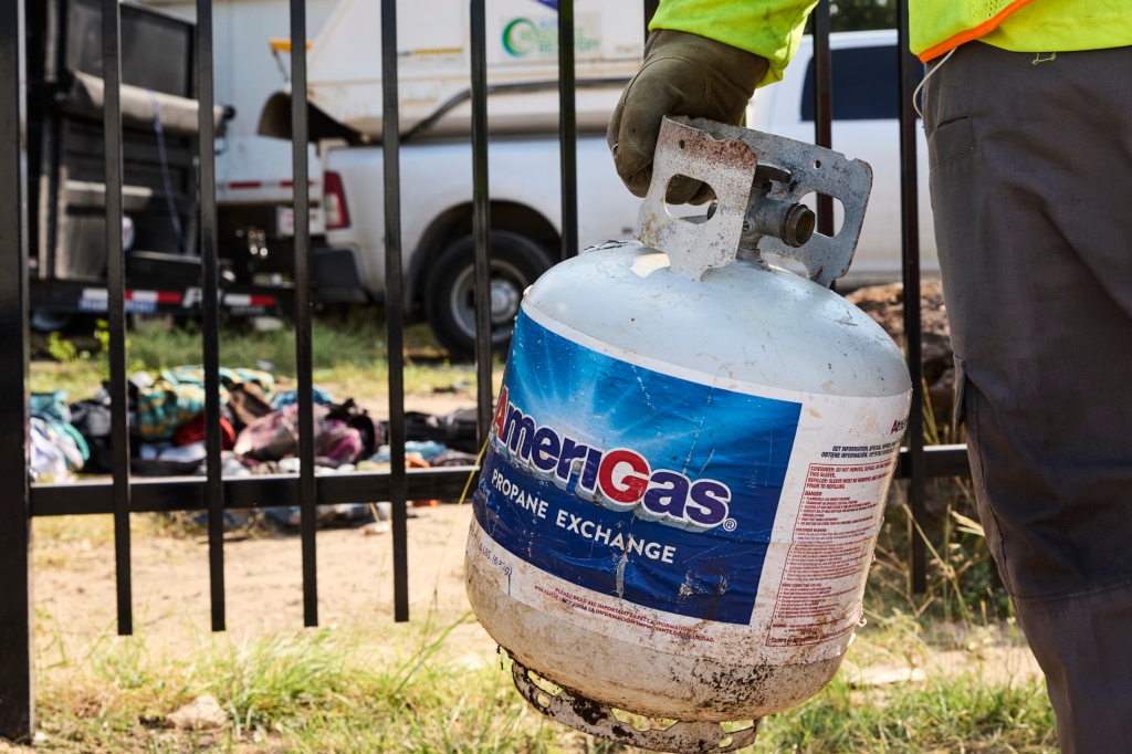 City of Austin work crews removed several propane tanks left by a large homeless encampment on June 21, 2023.