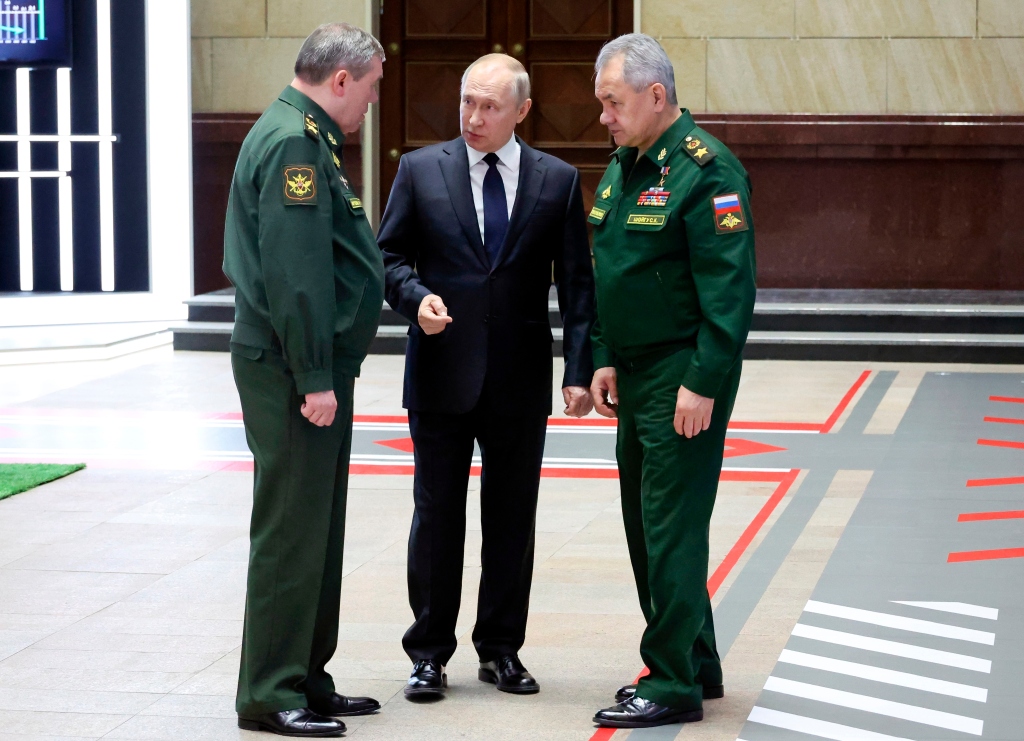 Russian President Vladimir Putin, center, speaks with Chief of the General Staff Gen. Valery Gerasimov, left, and Russian Defense Minister Sergei Shoigu,