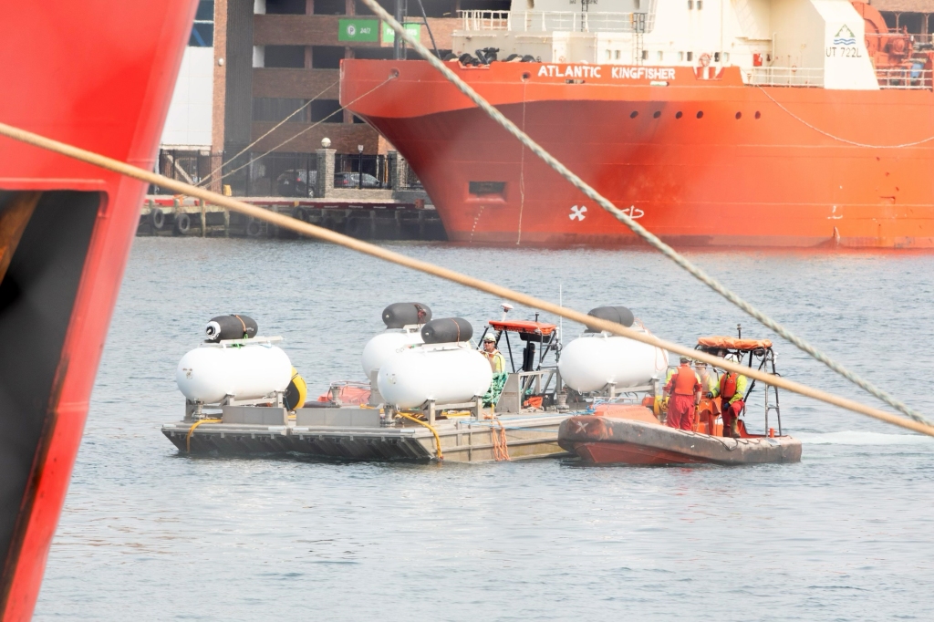 As the Polar Prince arrives back in harbor an empty launch platform is quietly towed behind it.