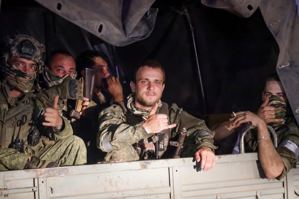 Members of the Wagner Group military company sit in their vehicle on a street in Rostov-on-Don, Russia, Saturday, June 24, 202.