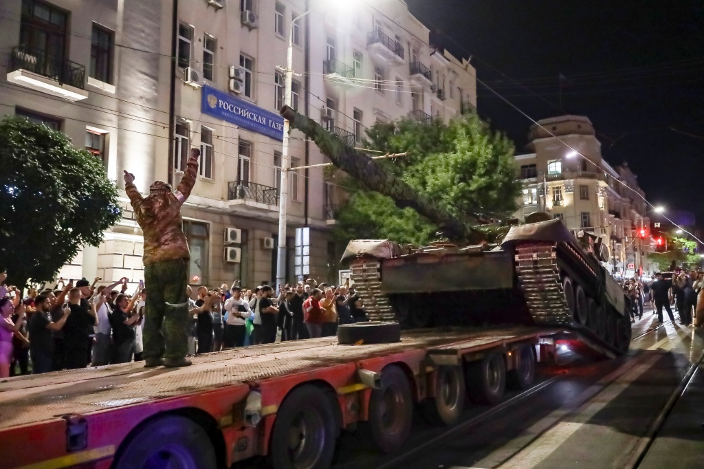 Members of the Wagner Group military company load their tank onto a truck on a street in Rostov-on-Don, Russia, Saturday, June 24, 2023