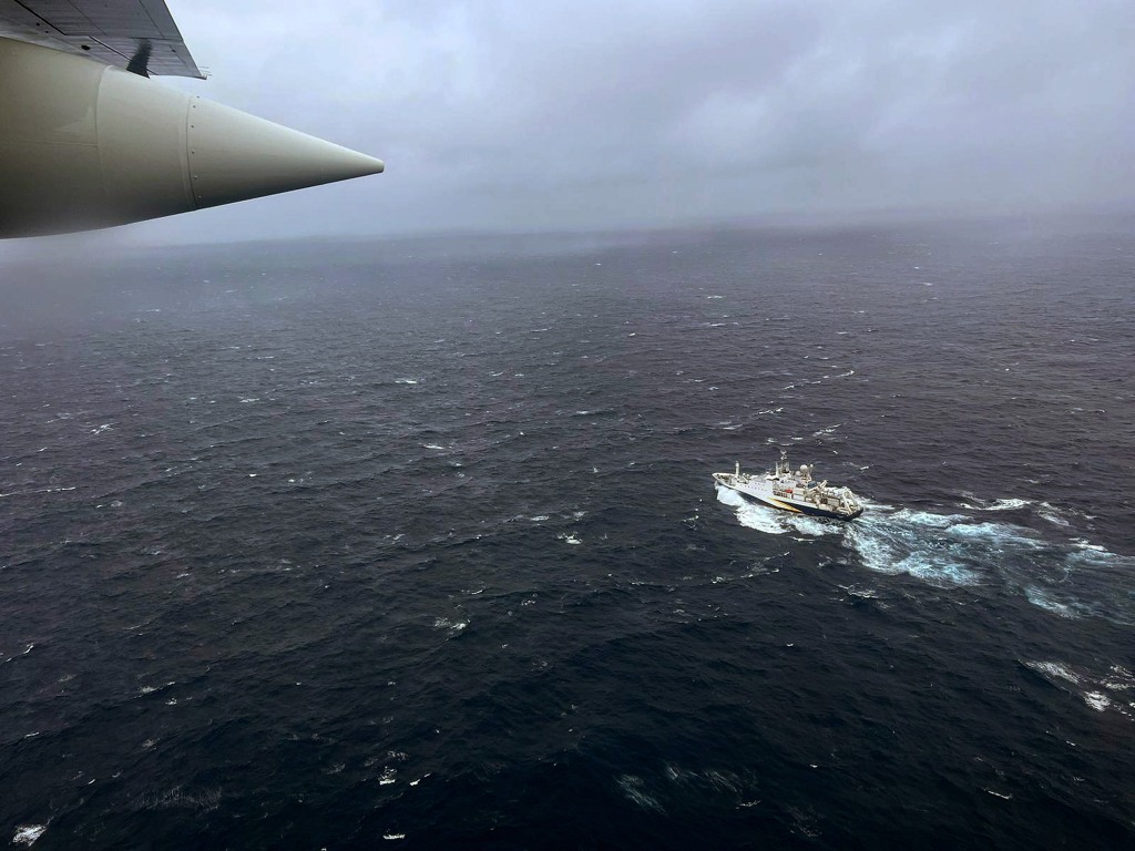 A Coast Guard Air Station Elizabeth City, North Carolina HC-130 Hercules airplane flies over the French research vessel, L'Atalante approximately 900 miles East of Cape Cod during the search for the 21-foot submersible, Titan, June 21, 2023 over the Atlantic Ocean.