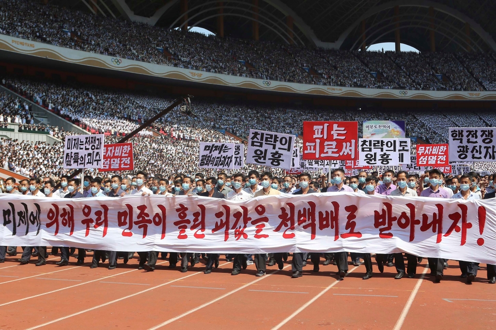 The signs read "Let us make the U.S. imperialists pay dearly for the blood shed by Korean nation!," "The U.S. is the chieftain of war and massacre," "merciless annihilation," "The U.S is the destroyer of peace," "chieftain of aggression," "blood to blood" and "nuclear war maniac." 