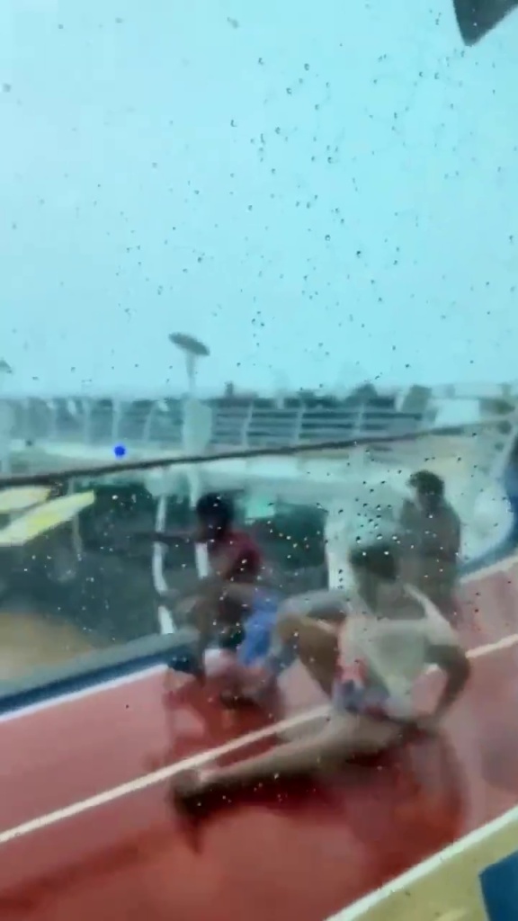 Passengers seen sliding across the deck