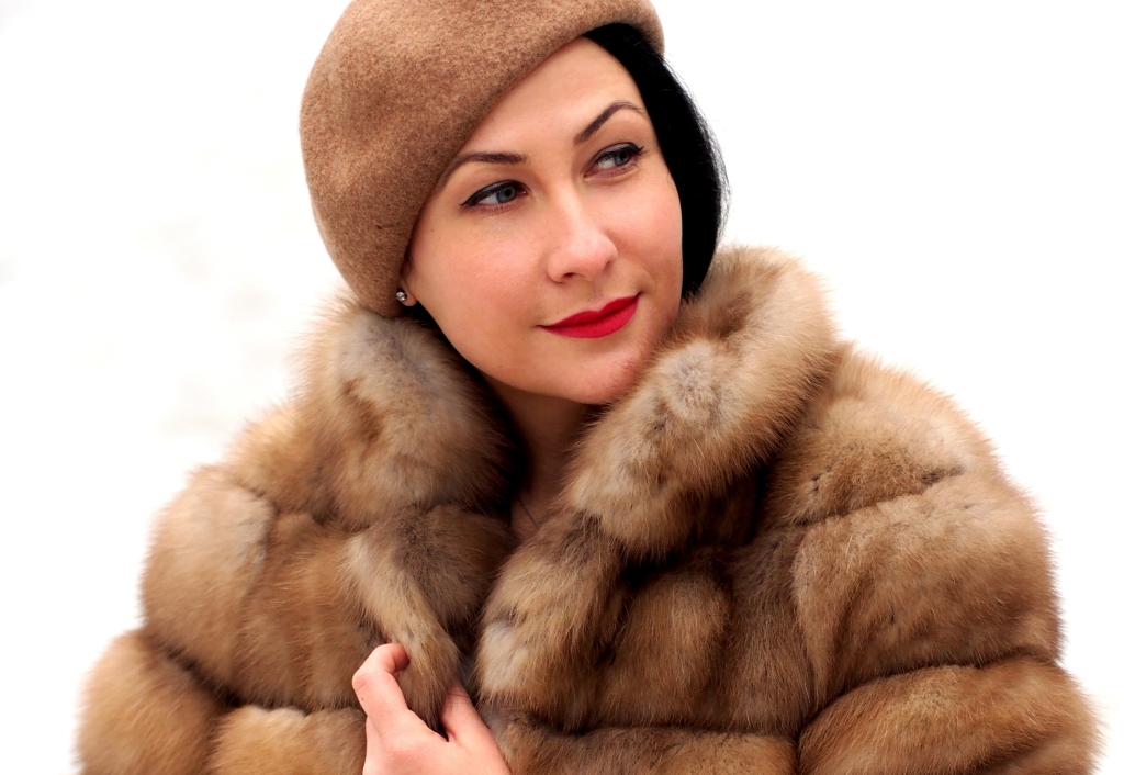 A woman wearing a fur coat