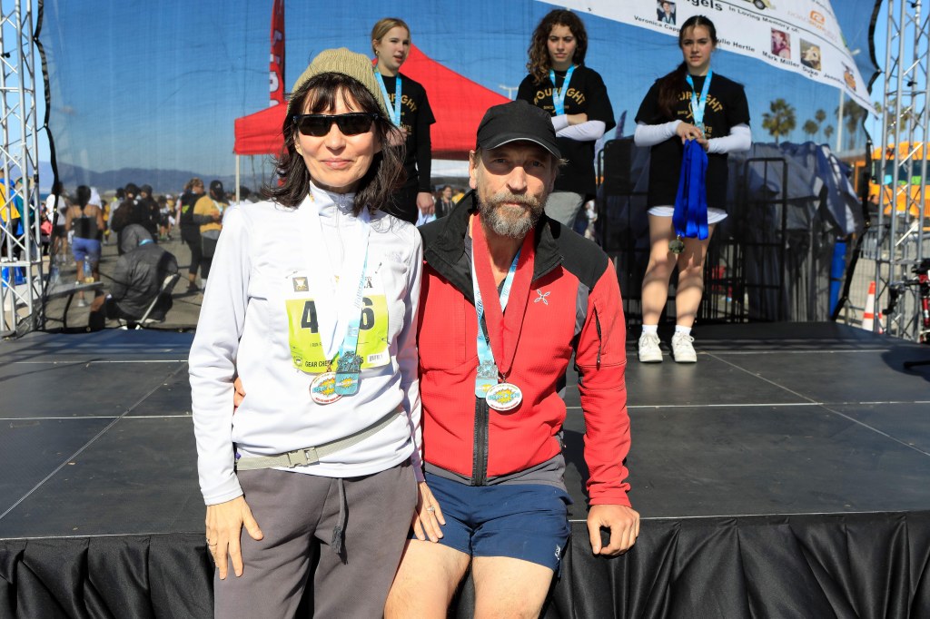 Julian Sands with his wife, Evgenia Citkowitz, after competing in the Student Run LA on November 13th, 2022 at Dockweiler Beach, in Los Angeles.