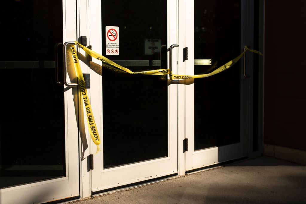 Police tape on door of classroom where professor and two students were stabbed Wednesday.