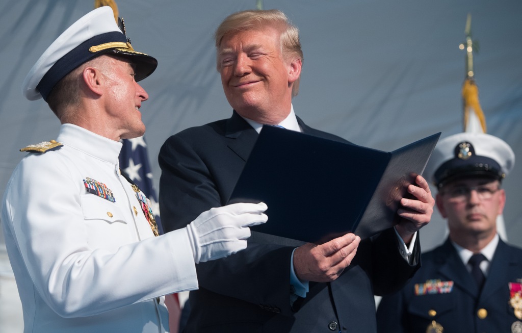 US President Donald Trump speaks with Admiral Paul Zukunft (L).