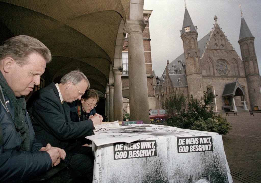 Protesters pray outside Dutch government buildings in The Hague, when the Upper House of Parliament began debating legalizing euthanasia in April 2001.