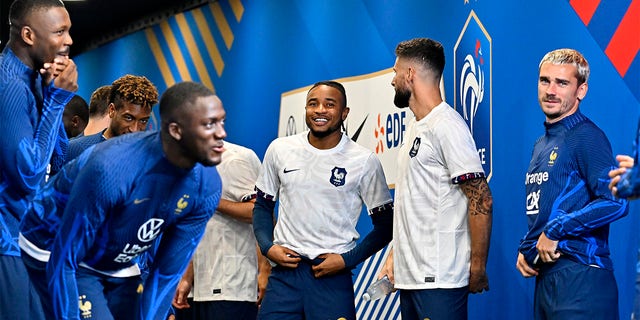 Christopher Nkunku smiles with teammates