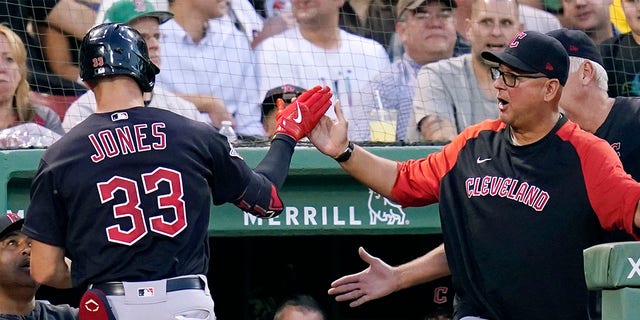 Nolan Jones is congratulated by Terry Francona