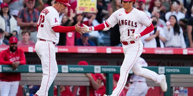 Shohei Ohtani and Bill Haselman celebrate