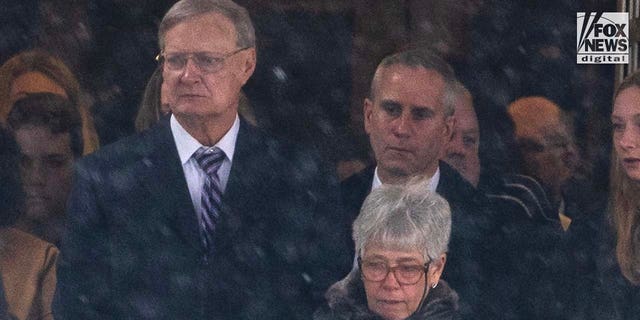 Bill Postle and Bernadette Postle, parents of Rebecca Bliefnick, attend their daughter’s funeral