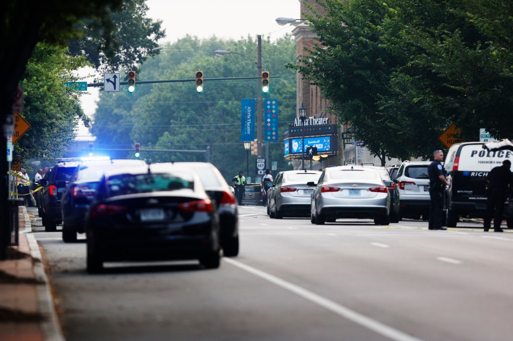 Cars and police gather around Altria Theater, the site of a shooting at the Huguenot High School graduation, Tuesday, June 6, 2023, in Richmond, Va. 