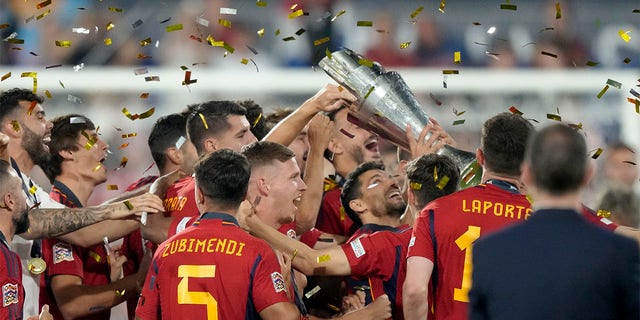 Spain players celebrate with trophy