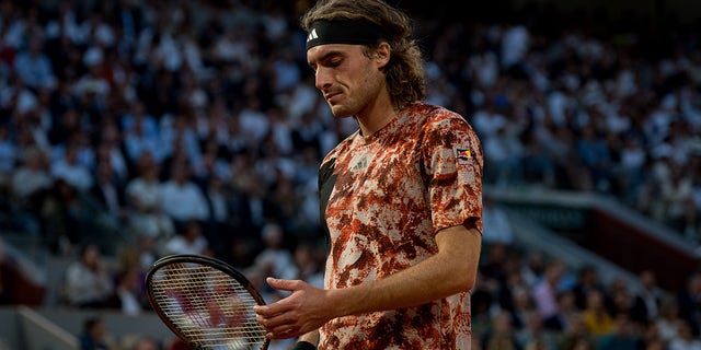 Stefanos Tsitsipas looks down