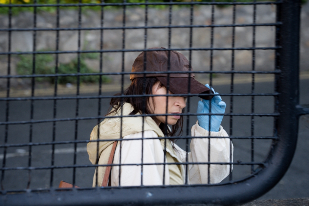 Shelly (Charlene McKenna) is wearing a disguise (brown baseball cap and a blue glove) in a scene from "Clean Sweep."