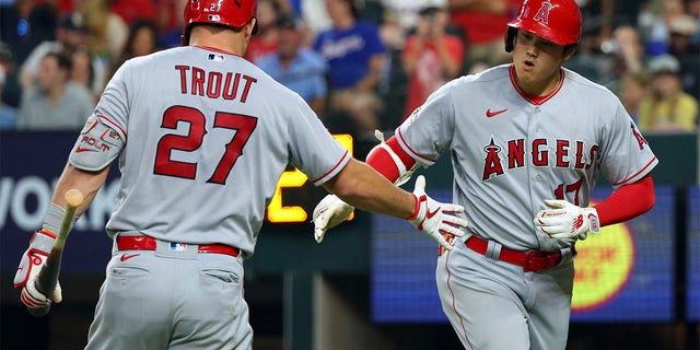 Shohei Ohtani celebrates with Mike Trout