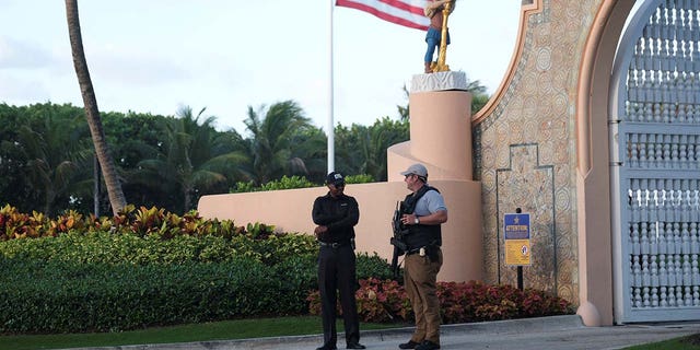 A Secret Service agent and a security guard officer guard the Mar-a-Lago home of former U.S. President Donald Trump