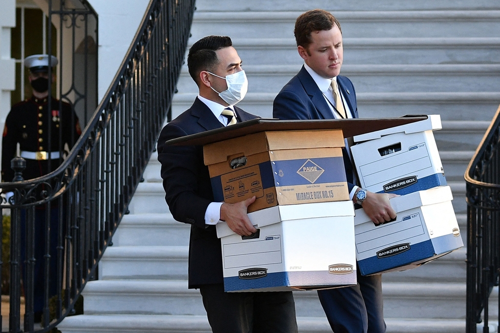 photo shows aides carrying boxes to Marine One before US president Donald Trump and wife Melania Trump departed from the White House on Trump's final day in office, in Washington, DC.